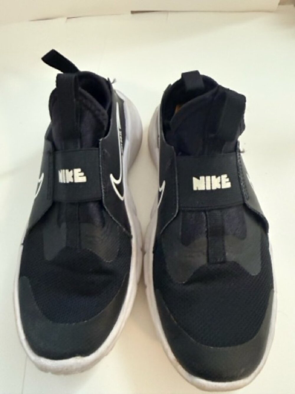 Nike Flex Runner slip-on sneakers in black with white soles